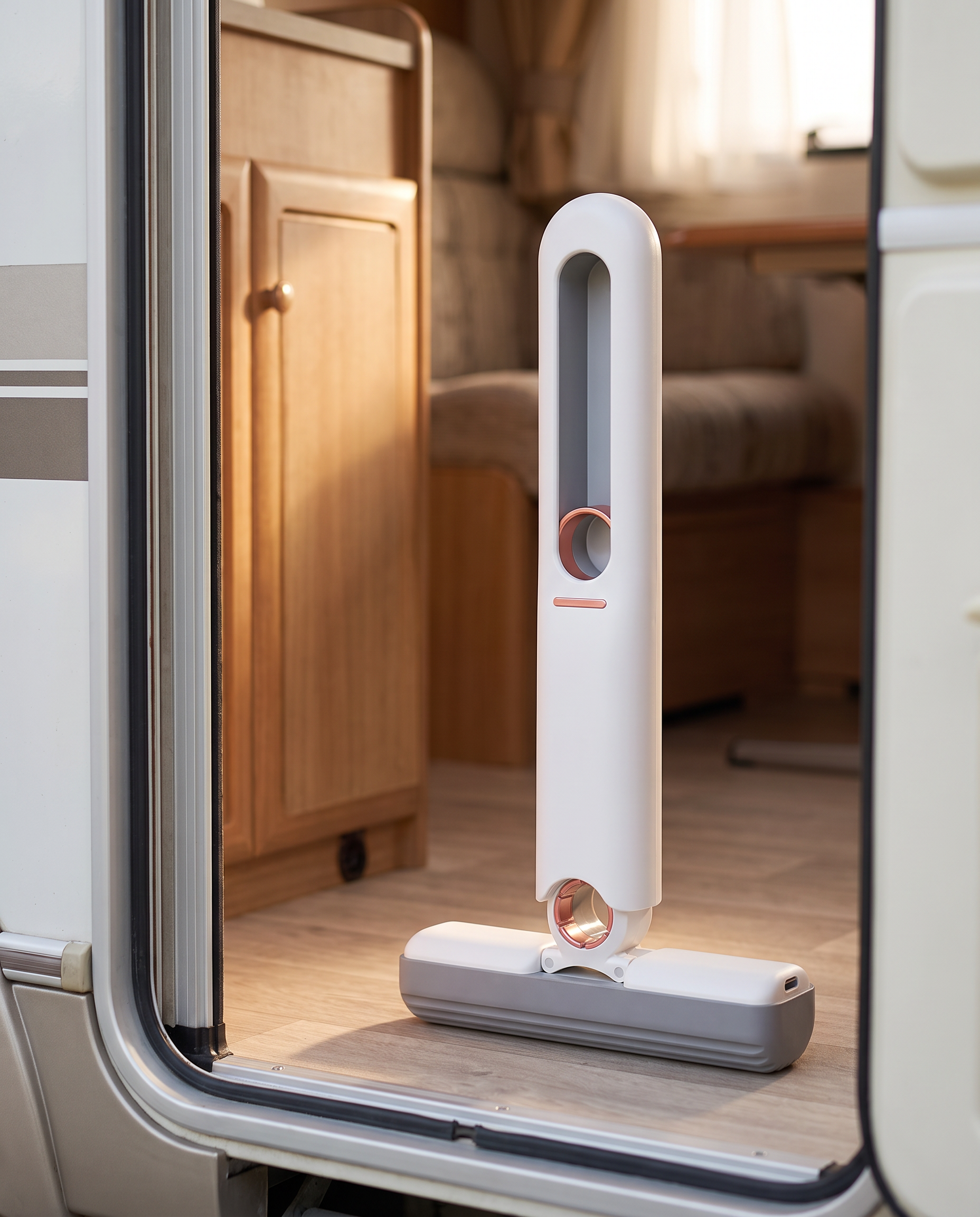 Compact vehicle and camp cleanup mop standing inside a caravan doorway