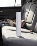 White reusable pet hair remover brush standing on a vehicle back seat